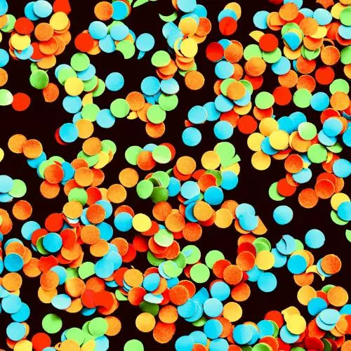 Circular colourful confetti on a dark background